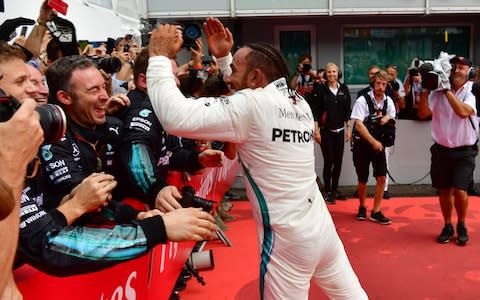 Mercedes' British driver Lewis Hamilton celebrates with his staff after winning the German Formula One Grand Prix at the Hockenheim racing circuit on July 22, 2018 in Hockenheim, southern Germany - Credit: afp