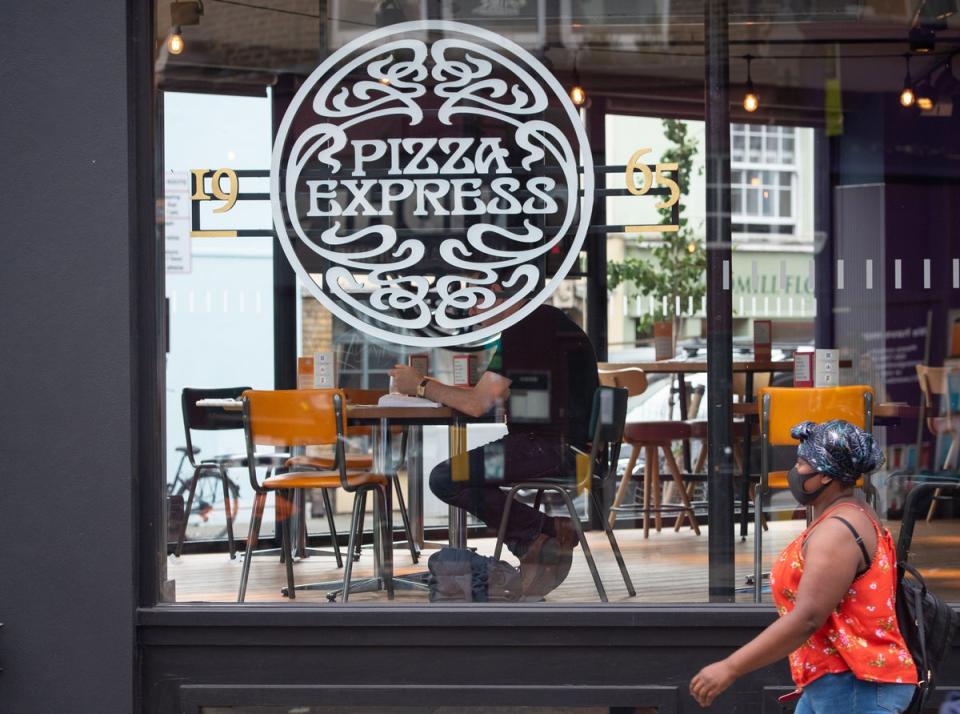 A woman passes a branch of Pizza Express in London, as the restaurant chain announced the appointed of new boss Paula MacKenzie (Dominic Lipinski/PA) (PA Archive)