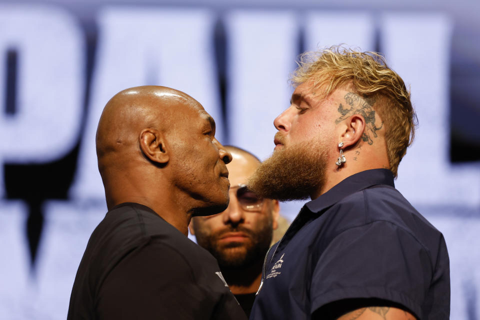 Mike Tyson and Jake Paul face off at the press conference for their upcoming boxing match