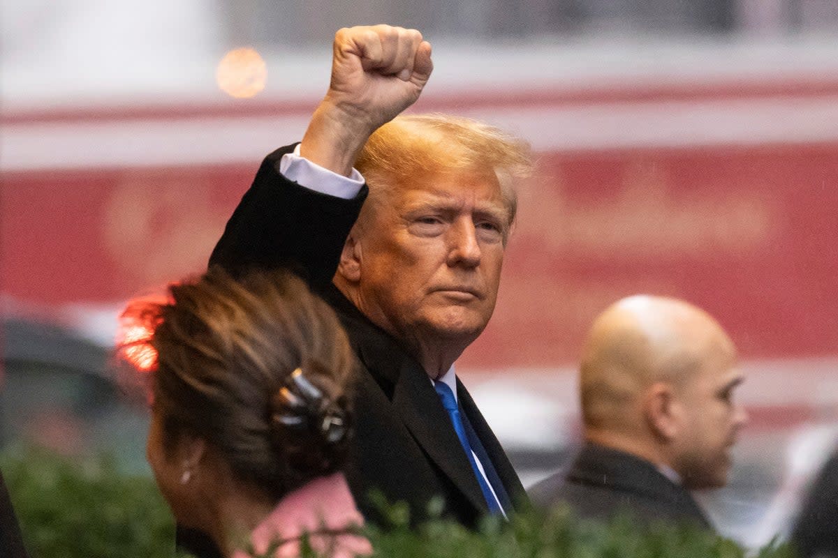 Trump raises his fist as he leaves his apartment  (Copyright 2024 The Associated Press. All rights reserved)