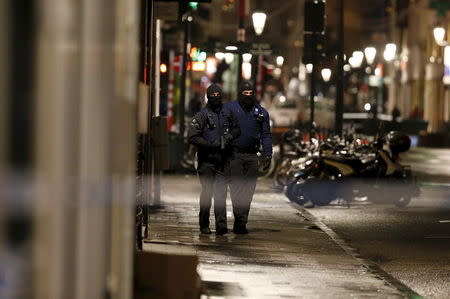 Belgian police officers patrol along a street during a continued high level of security following the recent deadly Paris attacks, in Brussels, Belgium, November 22, 2015. REUTERS/Youssef Boudlal