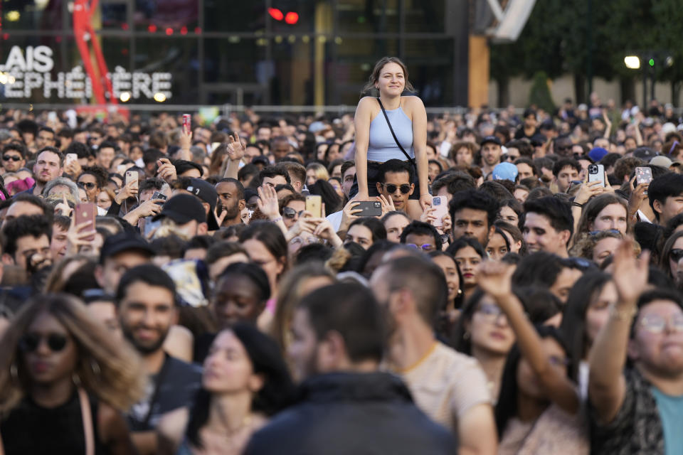 People enjoy the Power Our Planet concert on the sideline of the Climate Finance conference in Paris, Thursday, June 22, 2023. World leaders, heads of international organisations and activists are gathering in Paris for a two-day summit aimed at seeking better responses to tackle poverty and climate change issues by reshaping the global financial system. (AP Photo/Lewis Joly)