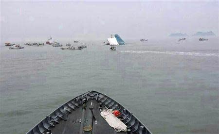 A part of a South Korean passenger ship (C) that has been sinking, is seen at the sea off Jindo April 16, 2014. REUTERS/South Korean Navy/Yonhap