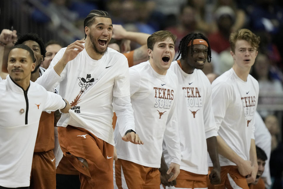 The Texas bench celebrates a basket during the second half of the NCAA college basketball championship game against Kansas in the Big 12 Conference tournament Saturday, March 11, 2023, in Kansas City, Mo. (AP Photo/Charlie Riedel)