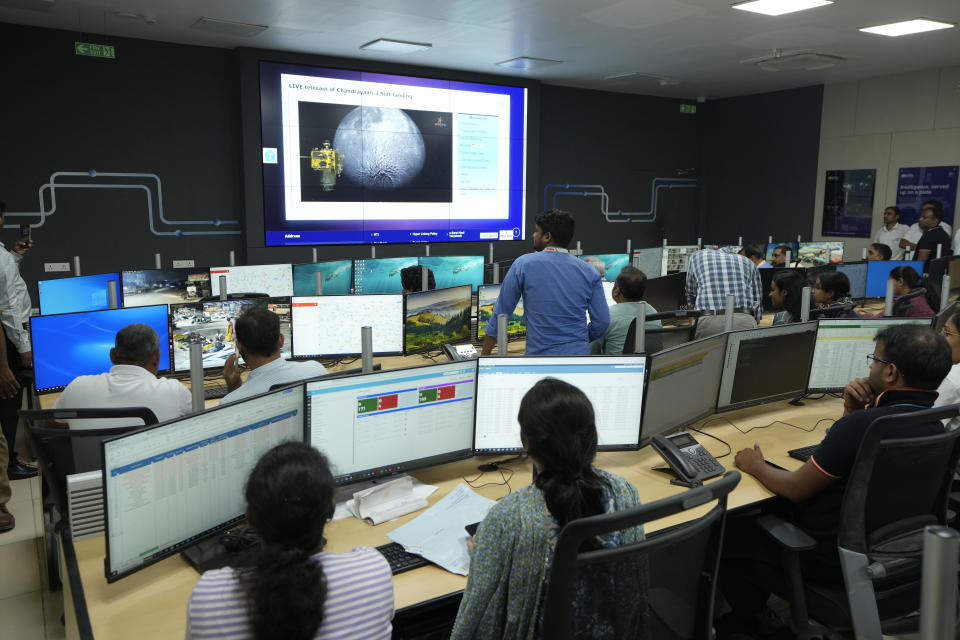 People watch the live telecast of the landing of Chandrayaan-3, at the Integrated Command Control Centre (ICCC) in Varanasi, India, Wednesday, Aug. 23, 2023. India has landed a spacecraft near the moon's south pole, an unchartered territory that scientists believe could hold vital reserves of frozen water and precious elements, as the country cements its growing prowess in space and technology. (AP Photo/Rajesh Kumar Singh)