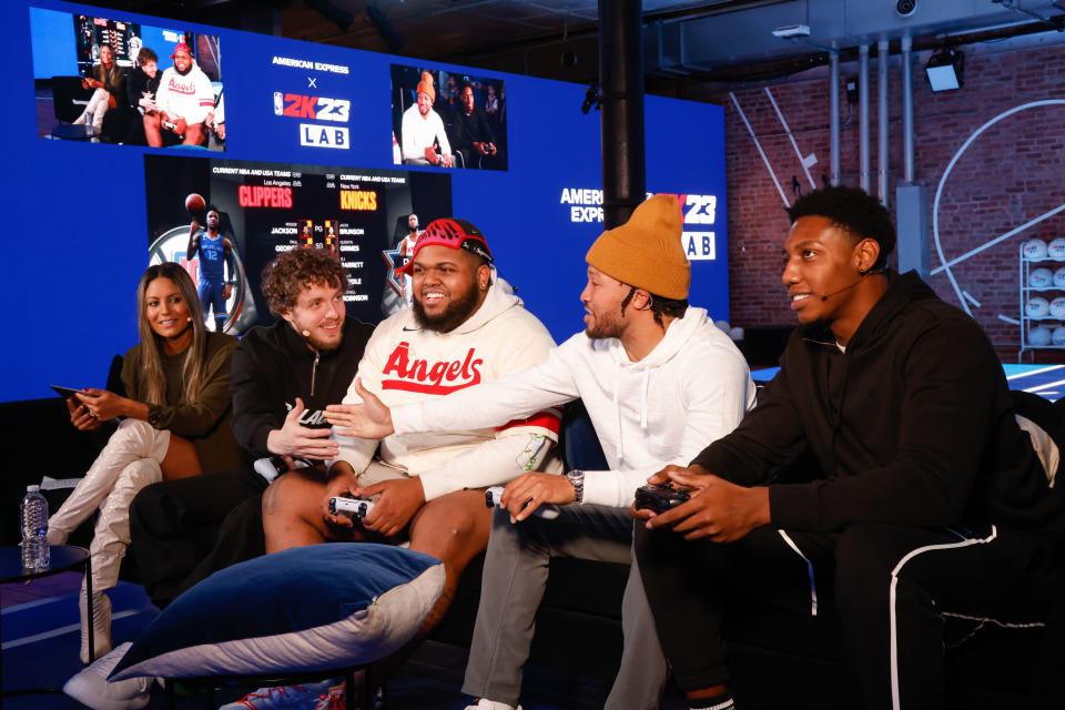 Alexis Morgan, Jack Harlow, Druski, Jalen Brunson, and RJ Barrett playing NBA 2K23 at the American Express x NBA 2K23 Gaming Lab.