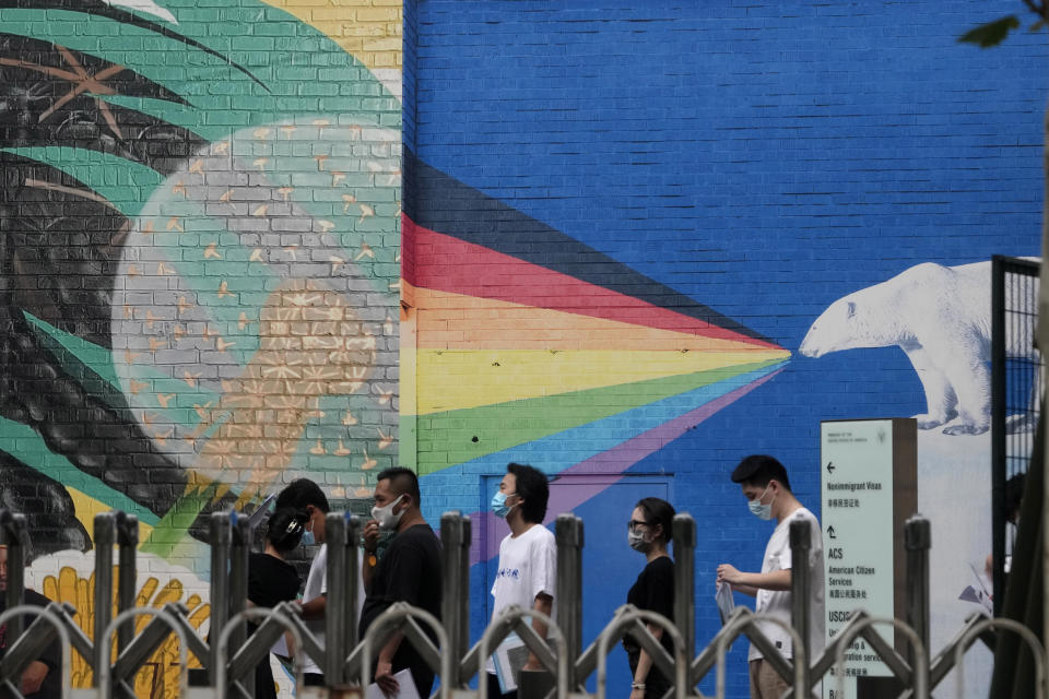 Visitors to the U.S. consular service line up outside the U.S. embassy in Beijing, Monday, Aug. 1, 2022. U.S. House Speaker Nancy Pelosi has arrived in Singapore, kicking off her Asian tour as questions swirled over a possible stop in Taiwan that has fueled tension with Beijing. (AP Photo/Ng Han Guan)