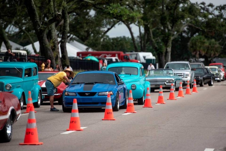 Orange cones section off cruisers from the rest of traffic on Highway 90 as cars arrive at Centennial Plaza in Gulfport for Cruisin’ The Coast on Monday, Oct. 4, 2021. The cones will also be placed along the highway in Biloxi Friday to provide a lane, if needed, for emergency access.