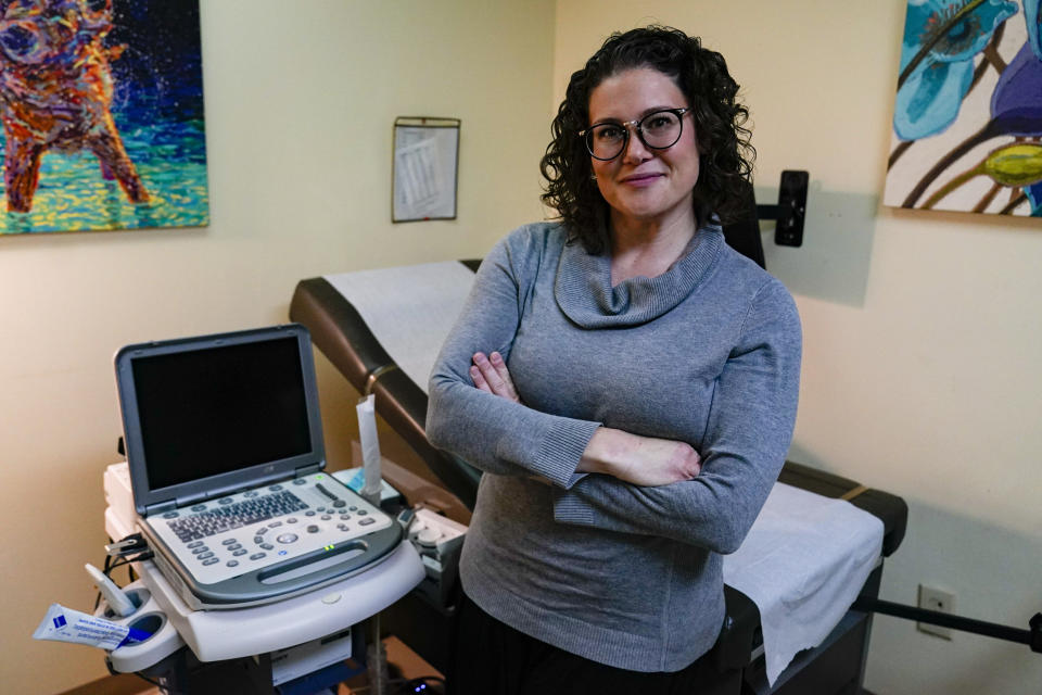 Dr. Katie McHugh, an obstetrician-gynecologist, poses in the sonogram room at the Women's Med Center in Indianapolis, Friday, Sept. 23, 2022. Indiana abortion clinics began seeing patients again on Friday after an Indiana judge blocked the state's abortion ban from being enforced. The State has appealed the order. (AP Photo/Michael Conroy)