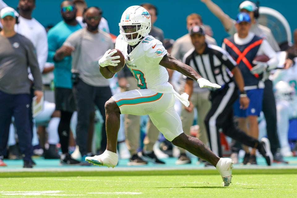 Dolphins receiver Tyreek Hill scores on 54-yard pass from Tua Tagovailoa in the first quarter of the 70-20 rout of the Denver Broncos.