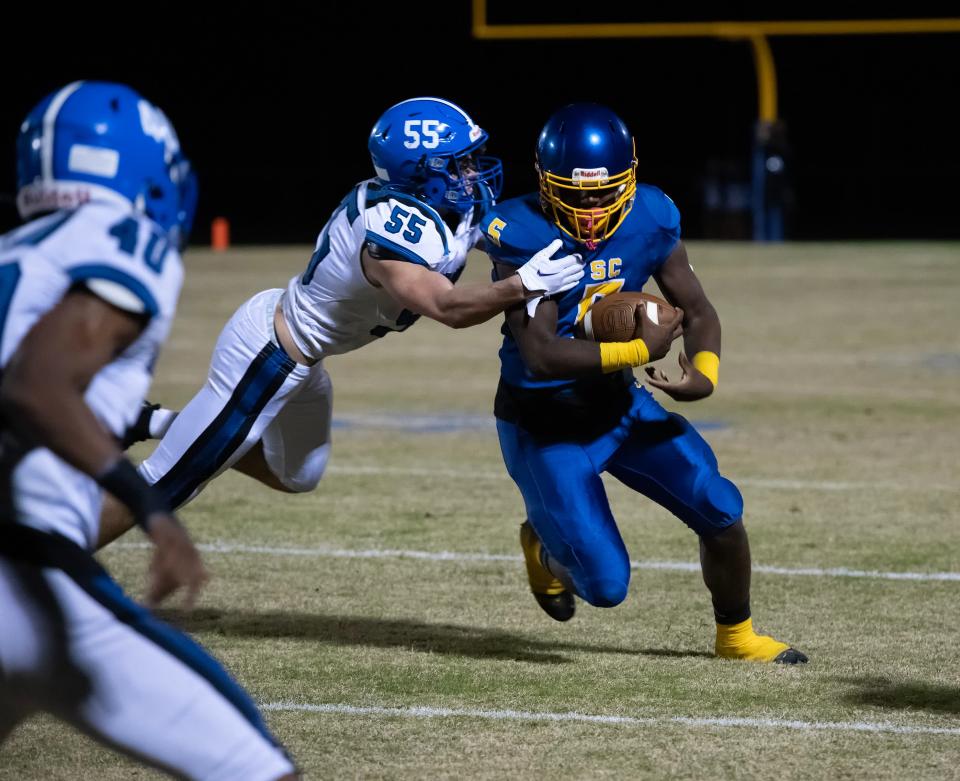 Sussex Central's Malik Bell (5) is tackled near the sideline by Middletown's Carter Boyd (55) in their game at Sussex Central High School.