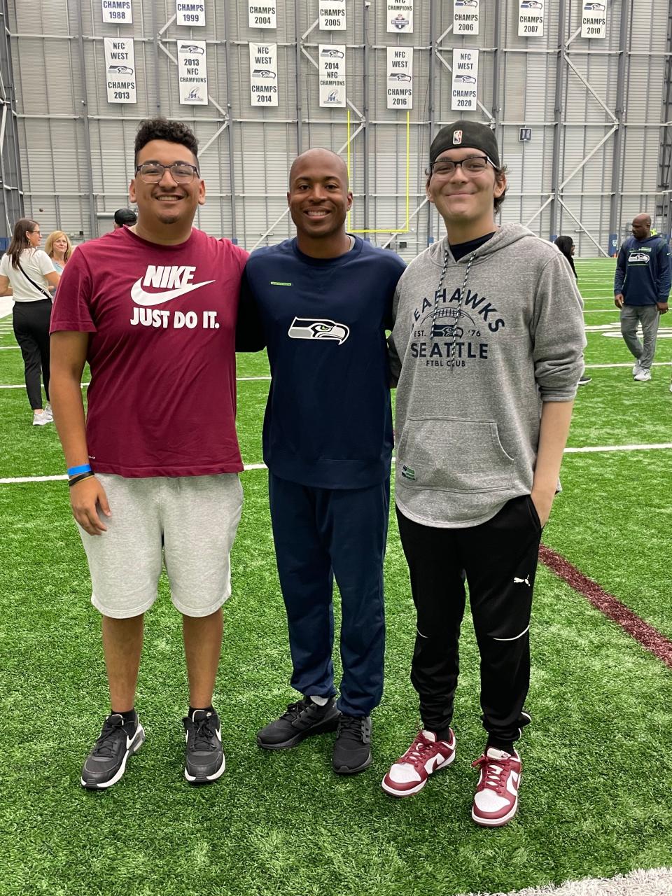Adan Munoz and his brother, Gustavo, pose for a photo with Seattle Seahawks wide receiver Tyler Lockett last September. Munoz passed away on April 15, 2023 after battling acute myeloid leukemia, a cancer of the bone marrow and blood.