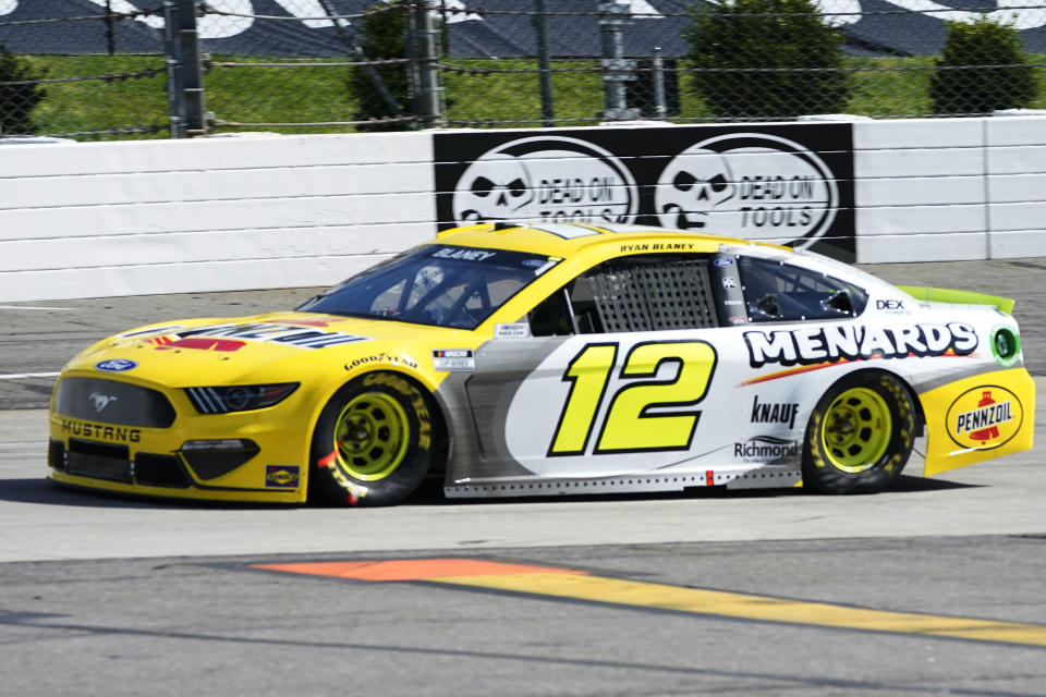 Ryan Blaney (12) drives into turn two during the NASCAR Cup Series auto race at Martinsville Speedway in Martinsville, Va., Sunday, April 11, 2021. (AP Photo/Steve Helber)