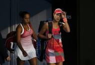 Serbia's Ana Ivanovic (R) and Madison Keys of the U.S. walk back on court after play in their third round match is resumed, at the Australian Open tennis tournament at Melbourne Park, Australia, January 23, 2016. REUTERS/Issei Kato