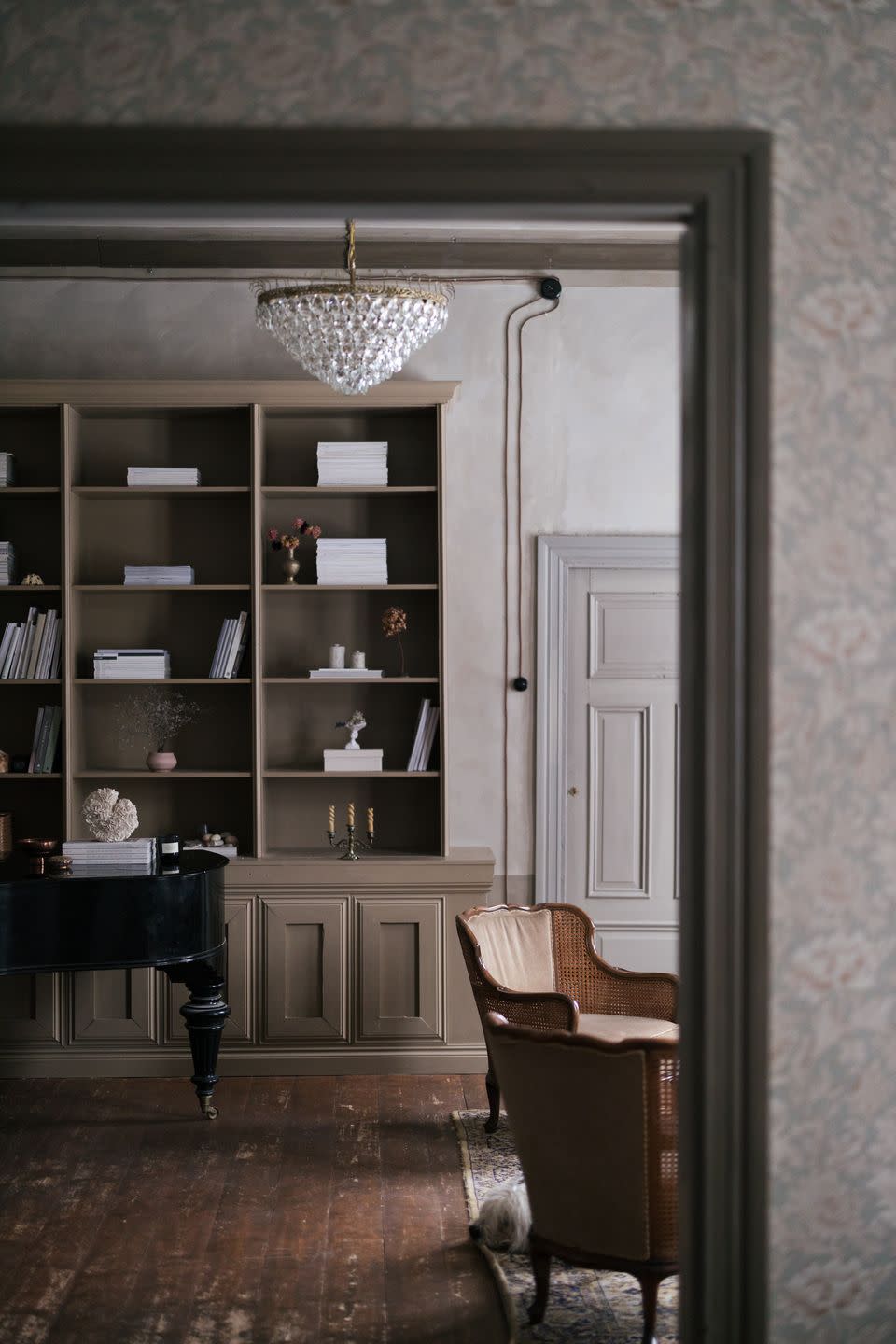 a room with a bookcase and a chair