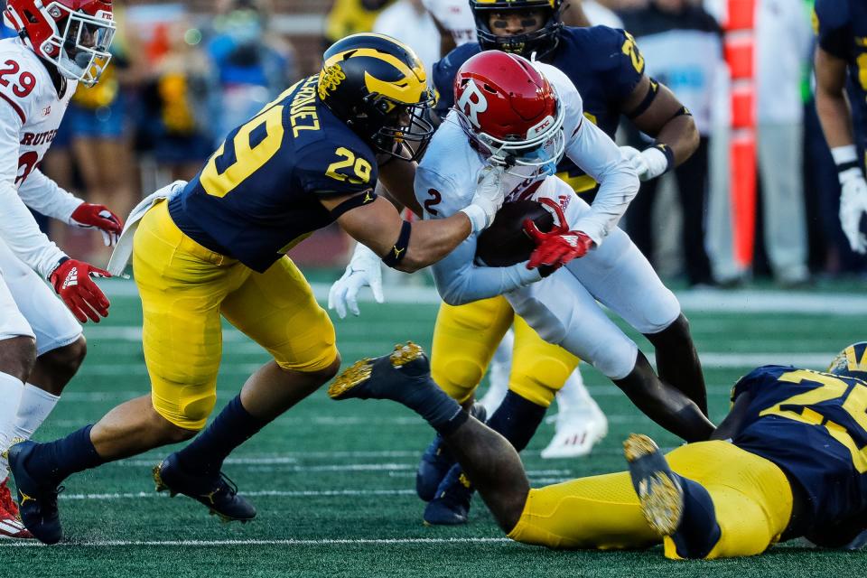 Michigan linebacker Joey Velazquez (29) tackles Rutgers wide receiver Aron Cruickshank (2) during the second half at Michigan Stadium in Ann Arbor on Saturday, Sept. 25, 2021.