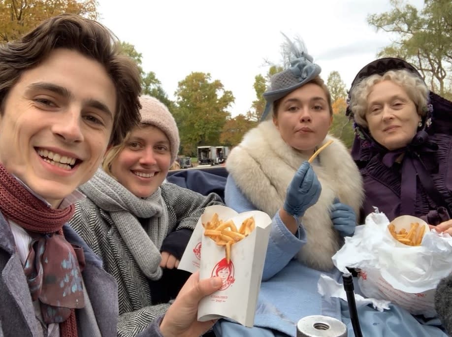 Timothee Chalamet shared a behind-the-scenes look on set of "Little Women" with director Greta Gerwig and co-stars Florence Pugh and Meryl Streep. The stars cuddled up for a quick lunch break with Wendy's fries.