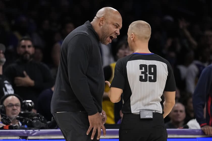 Los Angeles Lakers head coach Darvin Ham, left, yells at referee Tyler Ford after they received a technical foul