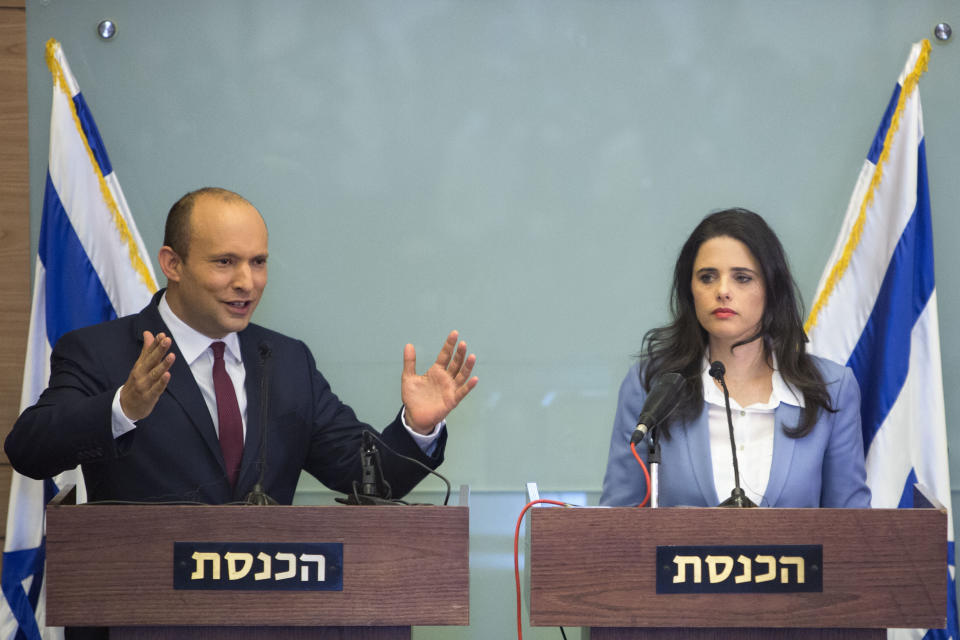 Israeli Education Minister Naftali Bennett, left, and Israeli Justice Minister Ayelet Shaked gesture as they speak during a press conference at the Knesset, Israel's parliament in Jerusalem, Monday, Nov. 19, 2018. Bennett, a senior coalition partner in Israel's government says he will not resign, averting early elections for now. (AP Photo/Sebastian Scheiner)