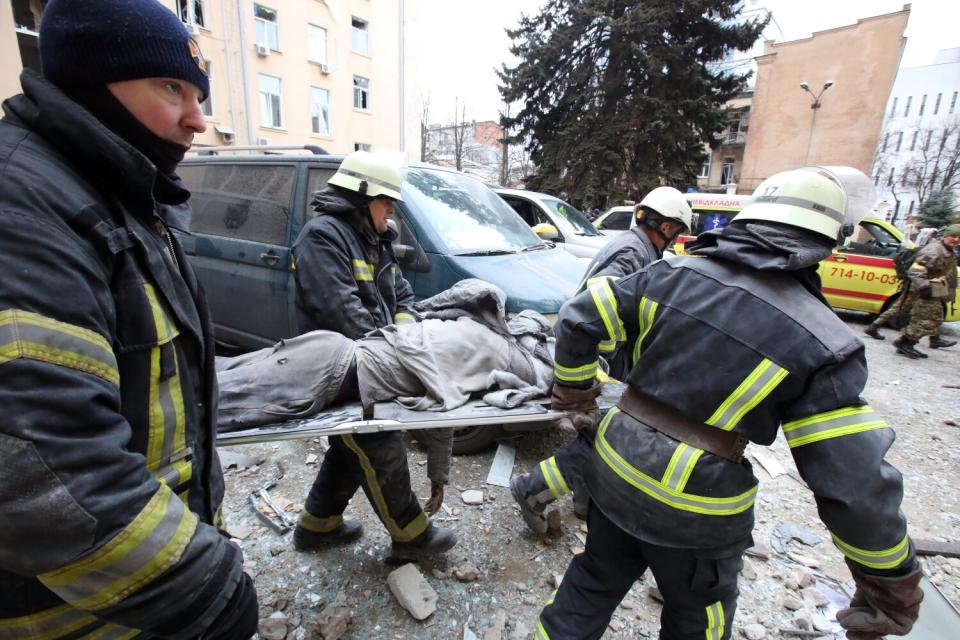 Rescuers in central Kharkiv, Ukraine, carry a wounded person on the stretcher after shelling by Russian troops.