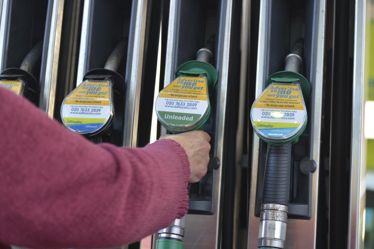 A person takes hold of a petrol pump at a British Petroleum petrol station on November 2, 2016 in Bolton, England. (Photo by Jonathan Nicholson/NurPhoto via Getty Images)