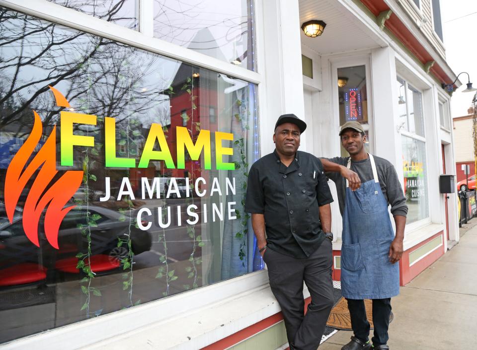 Christopher Nicely, left, and Ramon Hinds show off Flame, a new Jamaican restaurant in Somersworth Wednesday, Feb. 28, 2024.