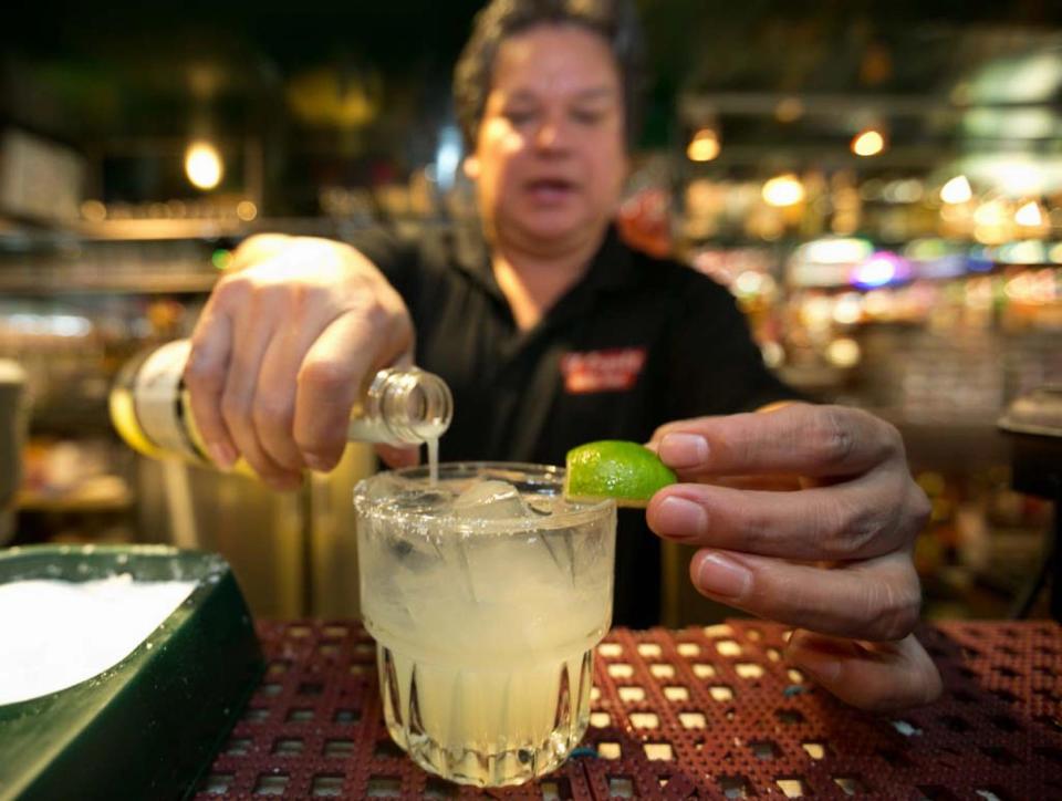 In this Monday, April 28, 2014 photo, bartender Mario Sanchez crafts a margarita cocktail at the bar of El Coyote, a Mexican restaurant in Los Angeles. Thousands of restaurateurs from coast to coast who have fallen victim to the Great Green Citrus Crisis of 2014. The lime has skyrocketed in price in recent weeks, quadrupling or, in some areas, going even higher. (AP Photo)