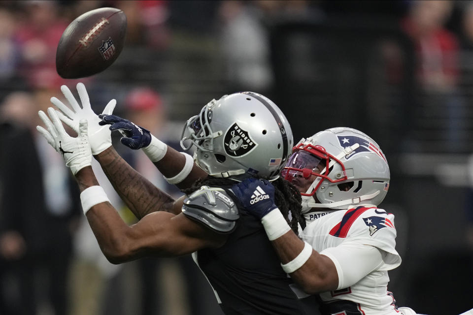 New England Patriots cornerback Marcus Jones (25) breaks up a pass intended for Las Vegas Raiders wide receiver Davante Adams during the first half of an NFL football game between the New England Patriots and Las Vegas Raiders, Sunday, Dec. 18, 2022, in Las Vegas. (AP Photo/John Locher)