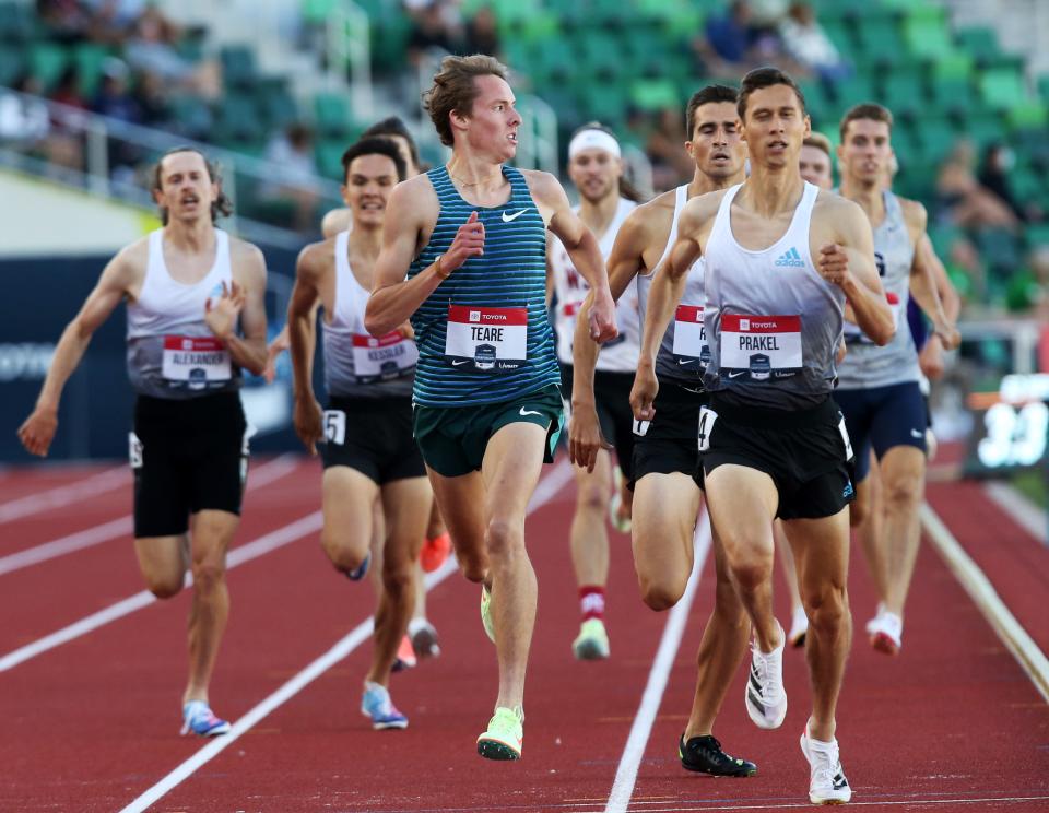 Former Oregon runner Cooper Teare, center, checks his position at the finish as he follows Sam Prakel, right, to advance out of his heat in the men's 1,500 meters on day one of the USA Track and Field Championships 2022 at Hayward Field in Eugene Thursday June 23, 2022.