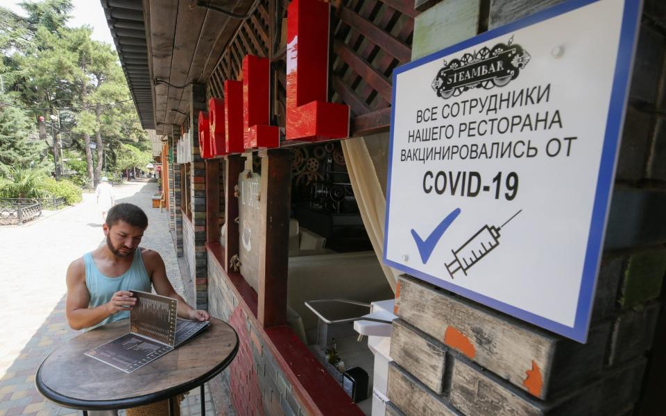 A sign in Alushta, Crimea which informs diners that all staff have been vaccinated against coronavirus - Sergei Malgavko/TASS