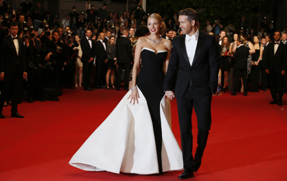 Actor Ryan Reynolds, right, and his wife, actress Blake Lively pose for photographers as they arrive for the screening of Captives at the 67th international film festival, Cannes, southern France, Friday, May 16, 2014. (AP Photo/Alastair Grant)