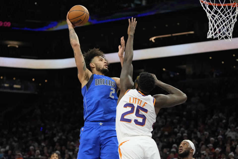 Dallas Mavericks center Dereck Lively II (2) shoots over Phoenix Suns forward Nassir Little (25) during the first half of an NBA basketball game, Monday, Dec. 25, 2023, in Phoenix. (AP Photo/Rick Scuteri)