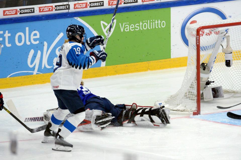 CORRECTS NAME OF FINNISH PLAYER TO PETRA NIEMINEN- Goalkeeper Alex Rigsby of the United States lies on the ice while Petra Nieminen of Finland starts celebrating her game-winning overtime goal which was later disallowed during the IIHF Women's Ice Hockey World Championships final match between the United States and Finland in Espoo, Finland, on Sunday, April 14, 2019. (Mikko Stig/Lehtikuva via AP)