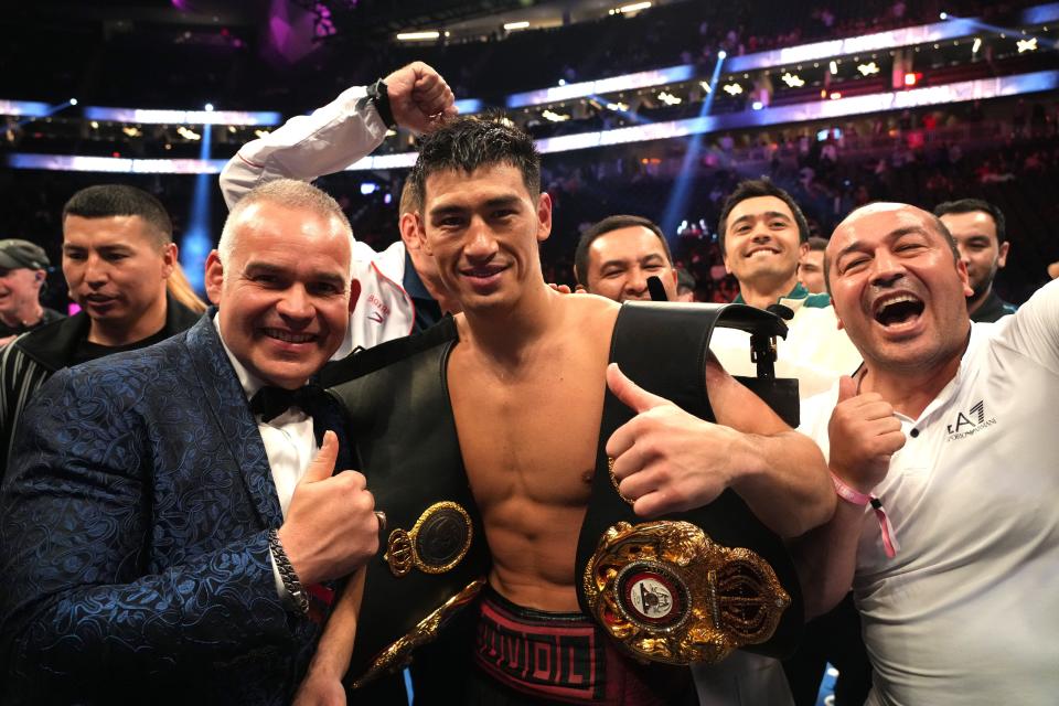 Dimitry Bivol (center) celebrates with his team after defeating Canelo Alvarez during their light heavyweight championship bout at T-Mobile Arena.