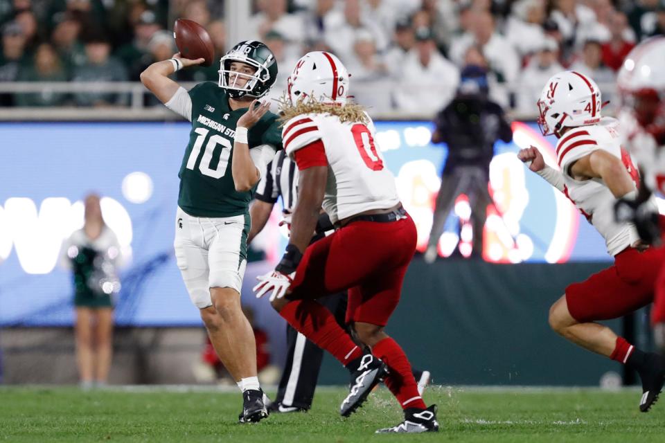 Michigan State Spartans quarterback Payton Thorne (10) passes the ball against Nebraska Cornhuskers linebacker Pheldarius Payne (0) during the second quarter at Spartan Stadium.