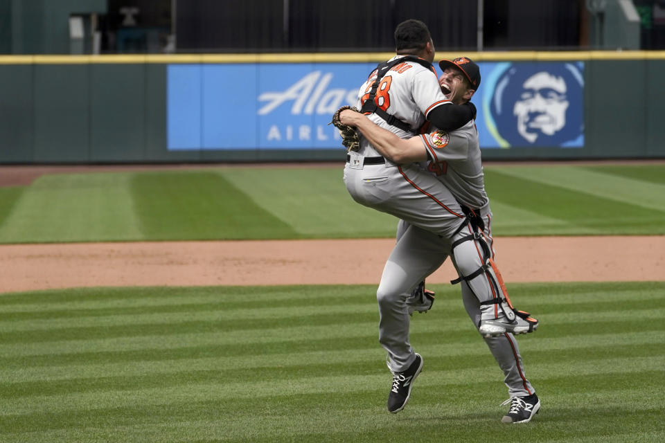 Baltimore Orioles starting pitcher John Means, right, celebrates with catcher Pedro Severino after Means threw a no-hitter baseball game against the Seattle Mariners, Wednesday, May 5, 2021, in Seattle. The Orioles won 6-0. (AP Photo/Ted S. Warren)