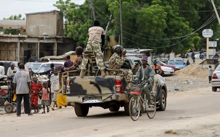 A man cycles past a military truck in Maiduguri, Borno State, Nigeria, August 31, 2016. REUTERS/Afolabi Sotunde