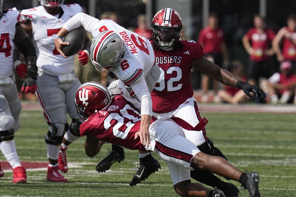 Ohio State quarterback Kyle McCord (6) is tackled by Indiana defensive back Louis Moore (20) during the first half of an NCAA college football game, Saturday, Sept. 2, 2023, in Bloomington, Ind. (AP Photo/Darron Cummings)