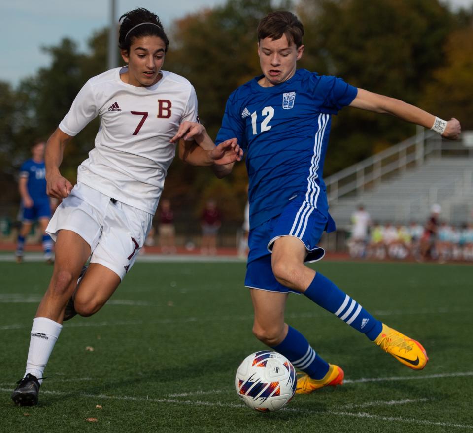 Brefeut Jesuit’s Julian Bell (7) is defended by Memorial’s Simon Theby (12) as the Brefeut Jesuit Braves play the Memorial Tigers for the 2A Boy’s Soccer Semi State game at Bundrant Stadium in Evansville, Ind., Saturday afternoon, Oct. 22, 2022.