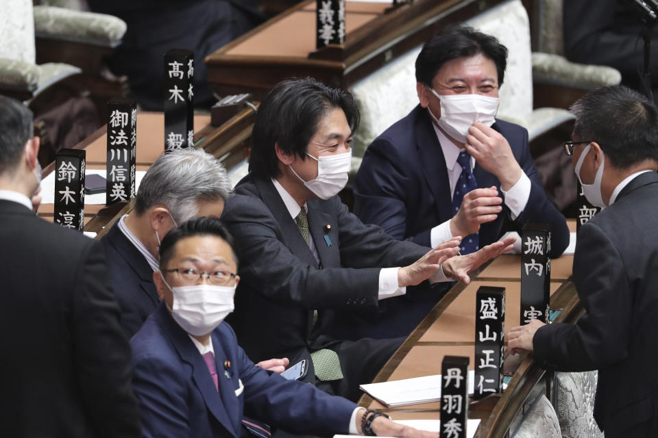 Japanese lawmakers wearing face masks to protect against the spread of the coronavirus attend an ordinary Diet session at the House of Representatives of parliament in Tokyo Monday, Jan. 18, 2021. (AP Photo/Koji Sasahara)