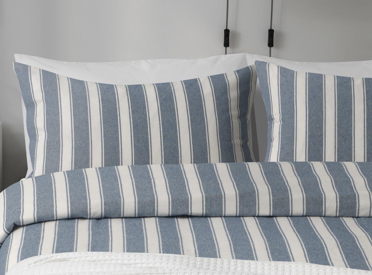  A close up of blue and white striped pillows. 