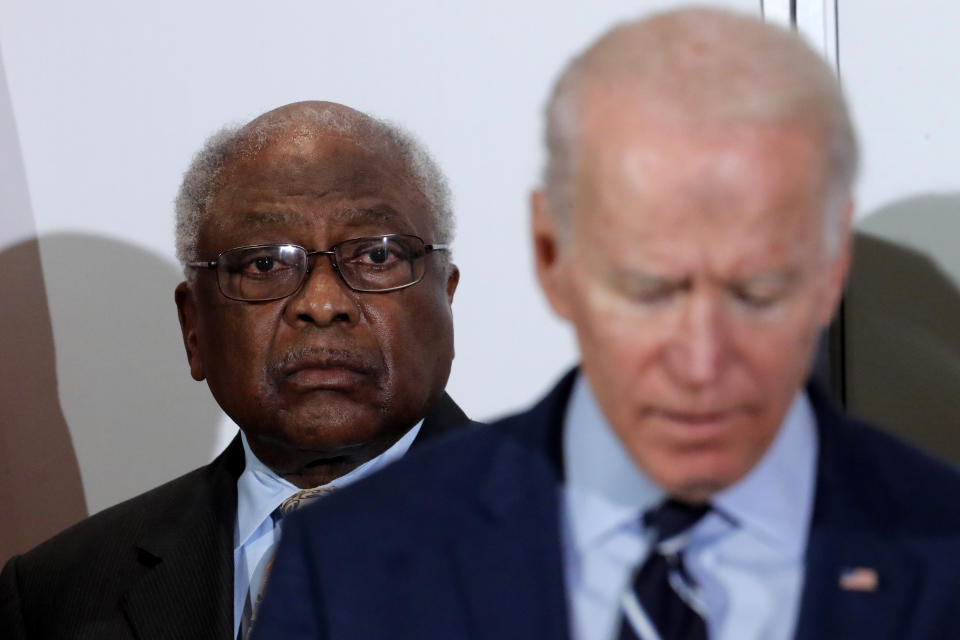 FILE - In this Feb. 26, 2020 file photo, House Majority Whip, Rep. Jim Clyburn, D-S.C., background, listens as Democratic presidential candidate former Vice President Joe Biden, speaks at an event where Clyburn endorsed him in North Charleston, S.C. “What I think we need to do now is support this new administration that seems to have leadership as a part of his agenda,” said Clyburn, a close ally of Biden. “We are where we are today because of a lack of leadership and I think that Joe Biden has demonstrated in his articulations that he’s prepared to provide the kind of leadership that we need.” (AP Photo/Gerald Herbert, File)