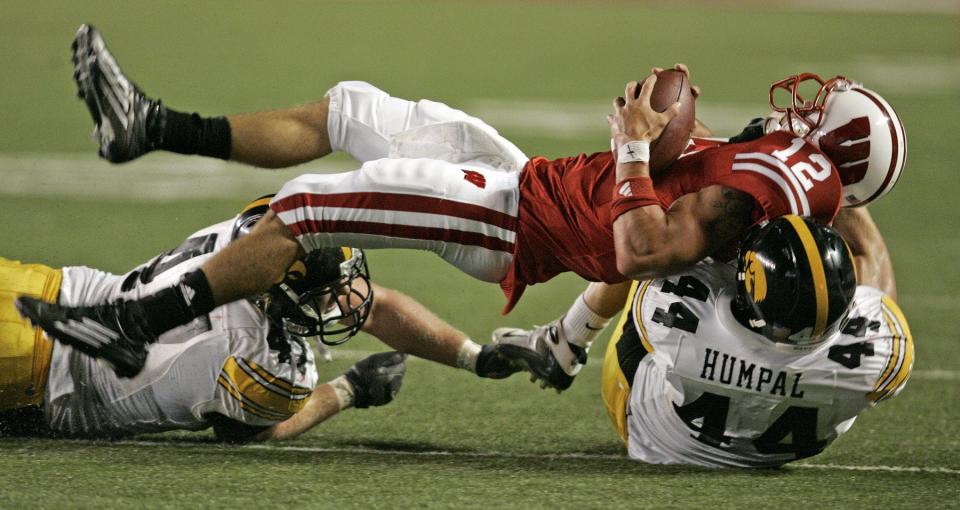 Former University of Iowa linebacker Mike Humpal (44) pulls down Wisconsin quarterback Tyler Donovan during a game against Wisconsin.