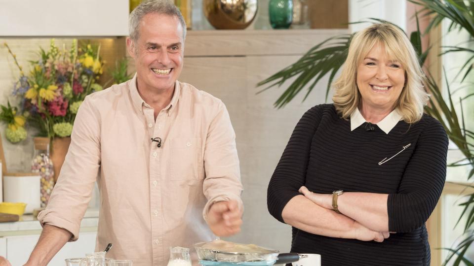 Phil Vickery and Fern Britton smiling as they stand together on This Morning in 2017