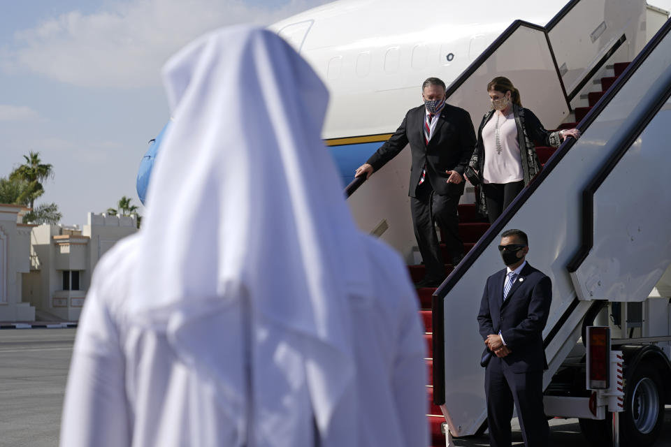 U.S. Secretary of State Mike Pompeo and his wife Susan step off a plane at Old Doha International Airport, Saturday, Nov. 21, 2020, in Doha, Qatar. (AP Photo/Patrick Semansky, Pool)