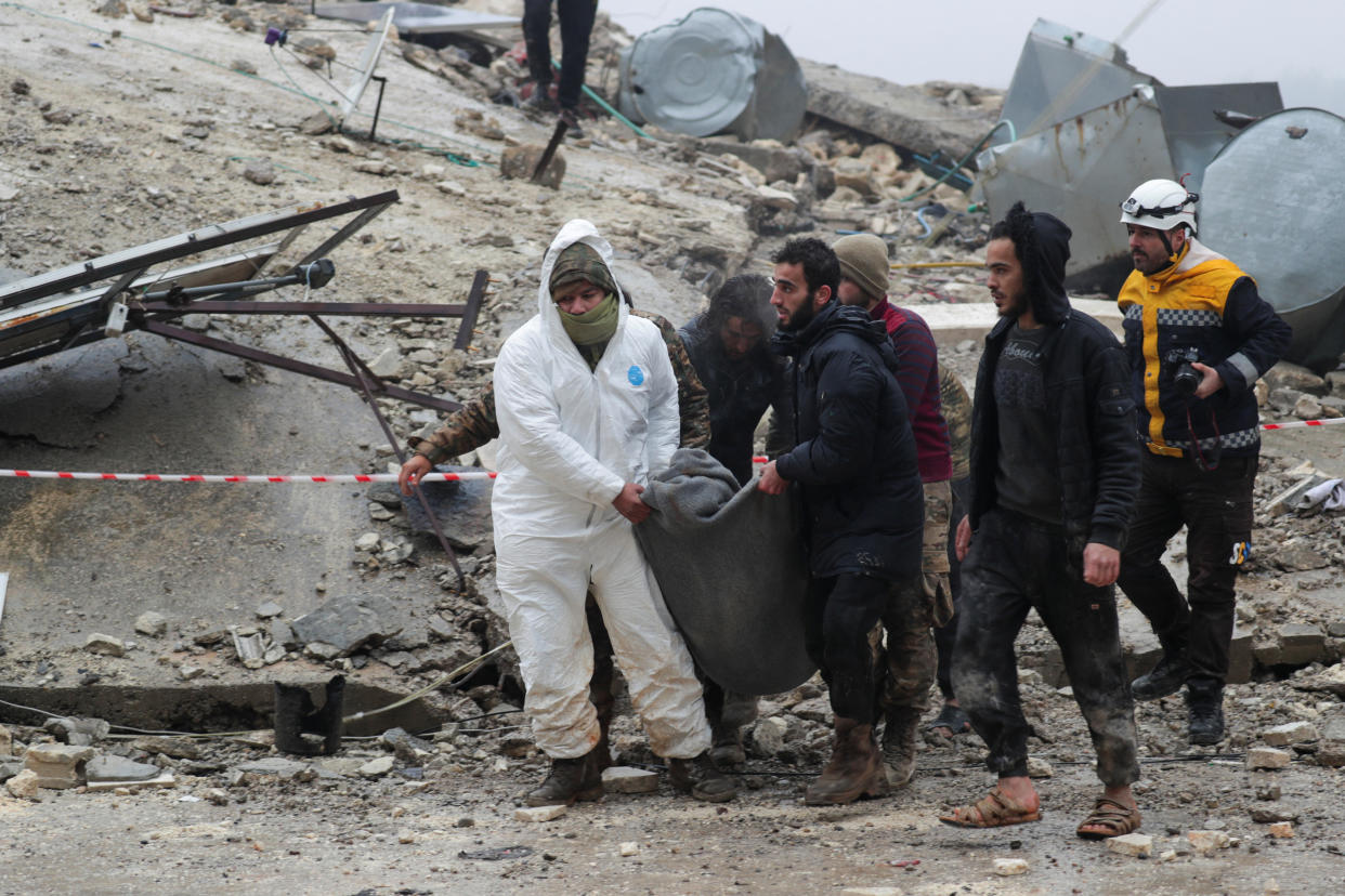 People carry a victim from the debris in Jandaris, Syria.