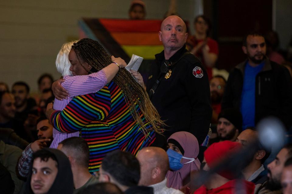 Jojo Gremel, 19, gets a hug after being booed during a Dearborn Public Schools board meeting inside Stout Middle School in Dearborn on Thursday, Oct. 13, 2022. 