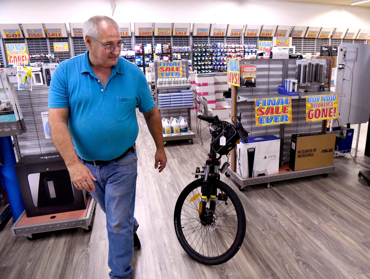 Richard Barron looks over his store, Eastland Office Supply, on Tuesday as he and the staff prepare it for a liquidation sale this week. The Eastland store is closing its doors after nearly 50 years.