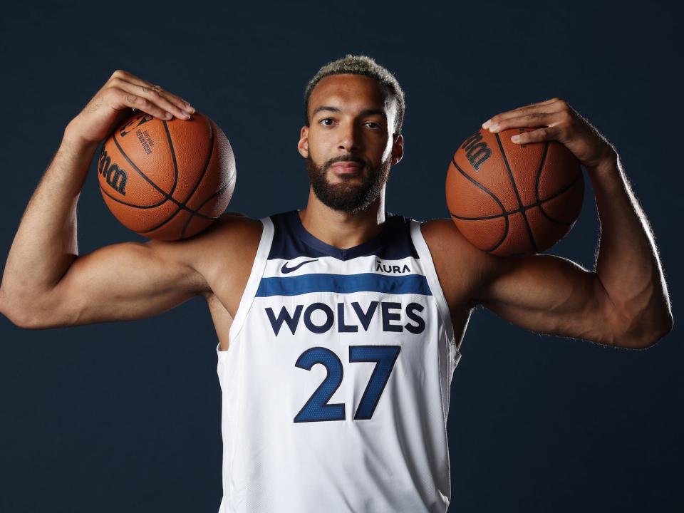 Rudy Gobert holds two basketballs on his shoulder during a Wolves photo shoot.