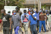 Prisoners walk out of prison following their release at Chikurubi prison on the outskirts of Harare, Saturday, April 17, 2021. Zimbabwe began the release of about 3,000 prisoners under a presidential amnesty aimed at easing congestion and minimizing the threat of COVID-19 across the country's overcrowded jails. (AP Photo/Tsvangirayi Mukwazhi)